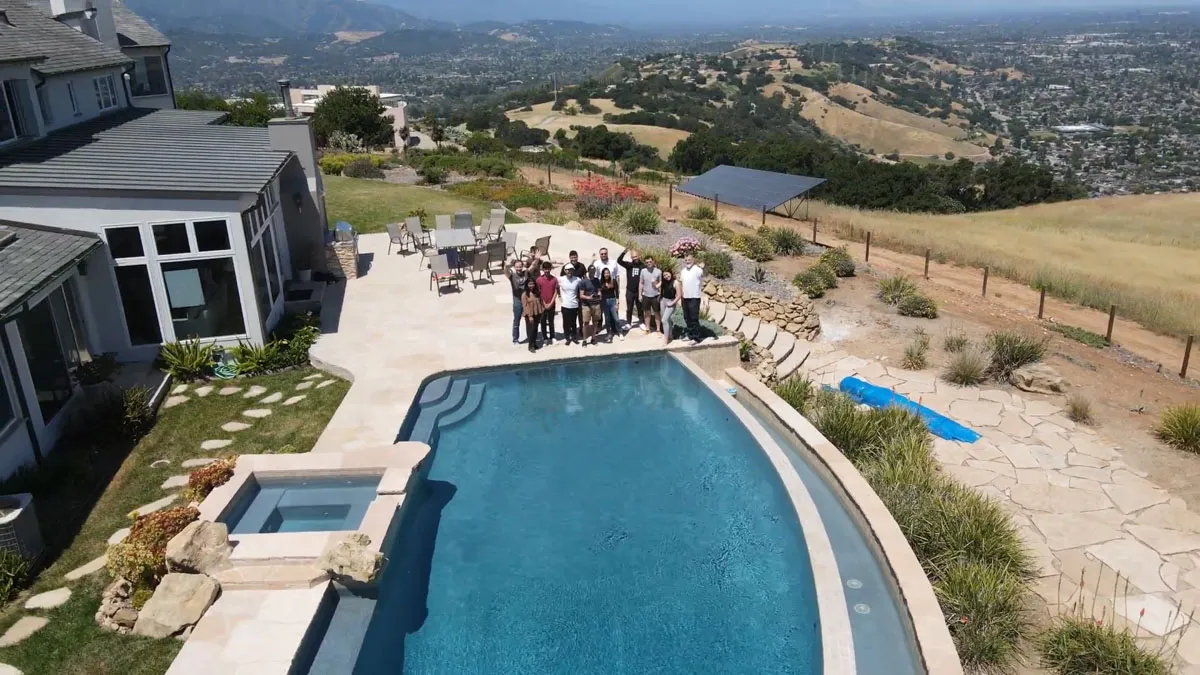 Inception Studio cohort 4 photo of cohort members at a distance standing behind a pool