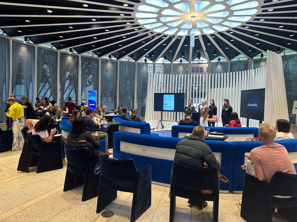 A group of founders listening to a presentation