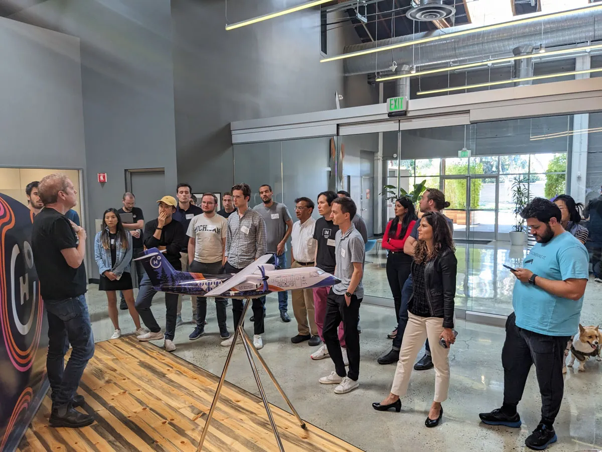 A group of founders standing in the Playground Global office listening to a tour guide